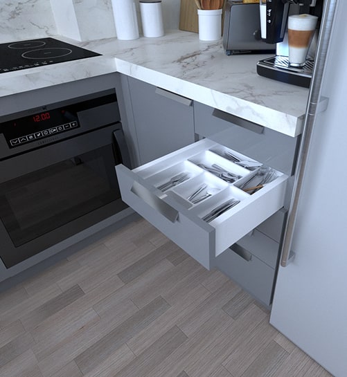 Kitchen drawer with a cutlery organizer beside the oven.
