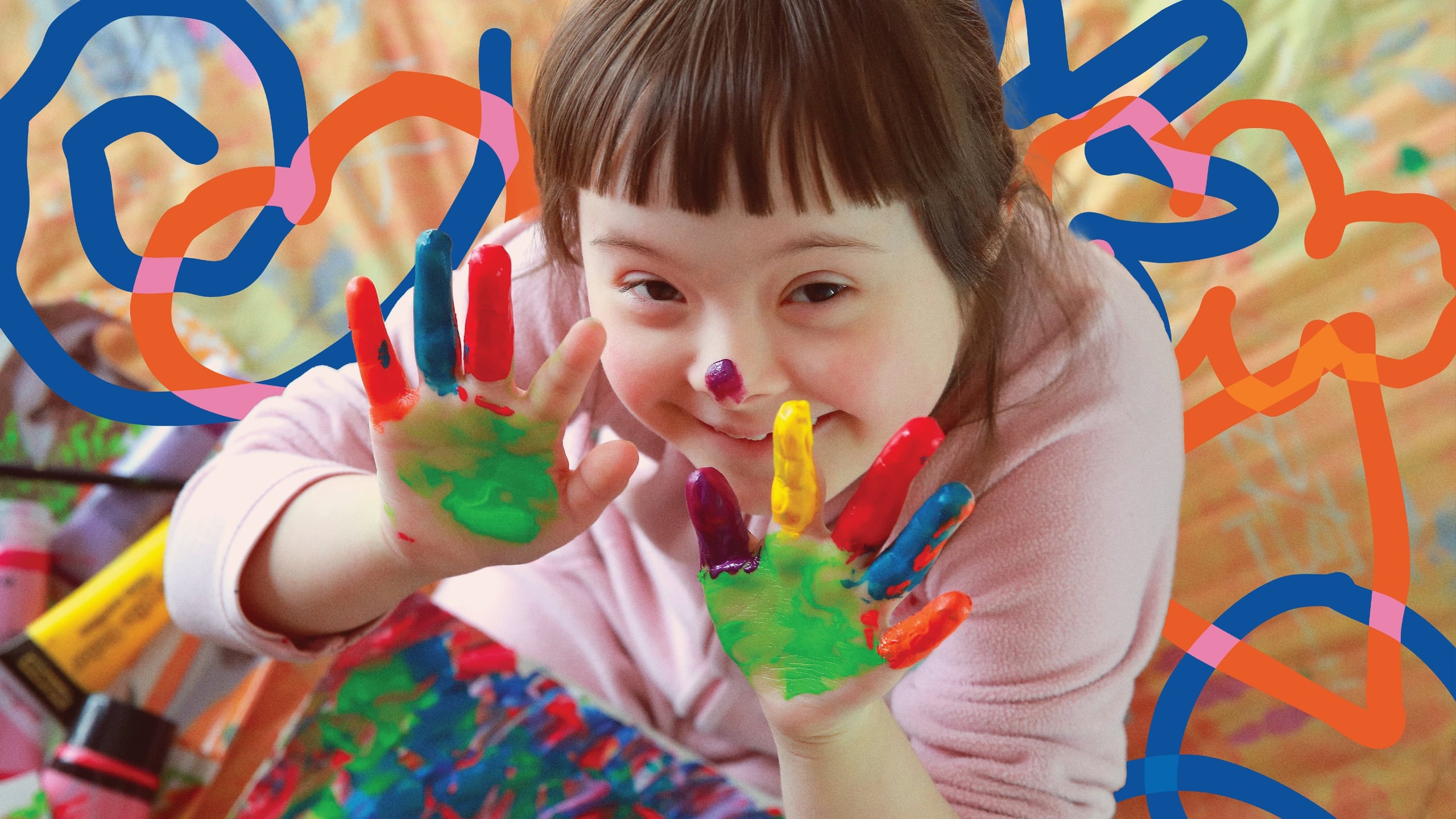 A young CERCIOEIRAS participant showing her hands covered in colourful paint.
