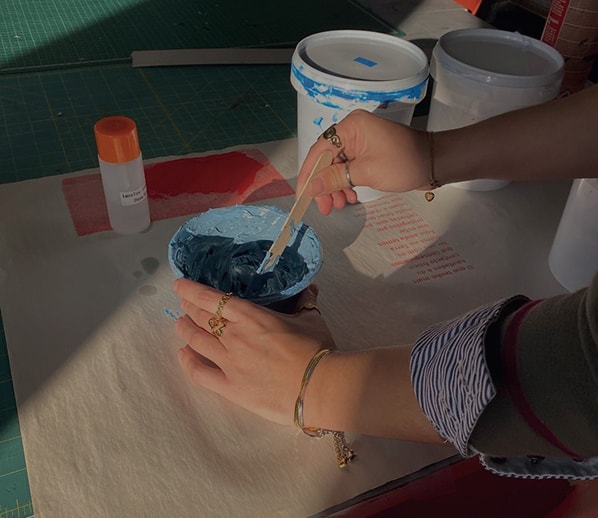 Preparing blue ink for screen printing.